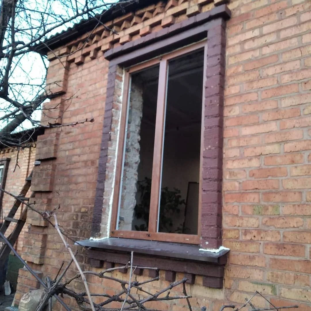 Коричневе вікно в цегляному прорізі — загальний зовнішній ракурс